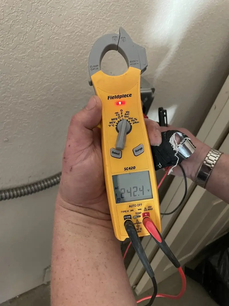 Voltage testing with clamp meter during Electrical Installation Services in Windermere